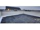 Spacious rooftop deck with sleek dark pavers and white perimeter walls at 10157 W 38Th Ave, Wheat Ridge, CO 80033