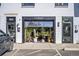 Charming storefront with an open garage door showcasing plants and a bench at 10157 W 38Th Ave, Wheat Ridge, CO 80033