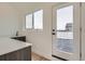 Wet bar area with dark wood cabinetry and access to the rooftop deck at 10157 W 38Th Ave, Wheat Ridge, CO 80033