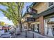 Attractive brick building housing a wine bar with outdoor seating and a tree-lined street at 10157 W 38Th Ave, Wheat Ridge, CO 80033