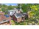 Aerial view of brick home with solar panels and beautiful yard shaded by trees, blending charm and functionality at 1260 S Emerson St, Denver, CO 80210
