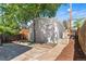 Backyard with concrete patio, mulch beds, a tree, and partial fencing for relaxing and entertaining at 1260 S Emerson St, Denver, CO 80210