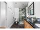 Modern bathroom features double sinks, frameless shower with multiple shower heads, and stylish fixtures at 1260 S Emerson St, Denver, CO 80210