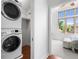 Bright bedroom with a large window and ceiling fan, adjacent to a convenient laundry area at 1260 S Emerson St, Denver, CO 80210