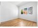 Bright, empty bedroom featuring hardwood floors and a large window, with ample natural light at 1260 S Emerson St, Denver, CO 80210