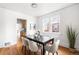 Bright dining room featuring hardwood floors, a modern table with seating, and ample natural light, perfect for entertaining at 1260 S Emerson St, Denver, CO 80210