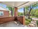 Covered front porch with brick supports and a view of the street and mature trees, creating a welcoming outdoor space at 1260 S Emerson St, Denver, CO 80210