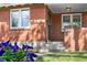 Close-up of the front entrance with brick facade and a concrete staircase at 1260 S Emerson St, Denver, CO 80210