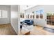 Bright and airy living room featuring a blue sofa, hardwood floors, and plenty of natural light at 1260 S Emerson St, Denver, CO 80210