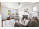 Bright living room featuring a fireplace, hardwood floors, stylish furniture, and large windows, creating an inviting space at 1260 S Emerson St, Denver, CO 80210