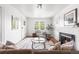 Bright and inviting living room with a fireplace, hardwood floors, stylish furnishings, and an abundance of natural light at 1260 S Emerson St, Denver, CO 80210