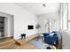 Bright living room featuring hardwood floors, a comfortable blue couch, and large windows for natural light at 1260 S Emerson St, Denver, CO 80210
