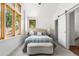 Bright bedroom with large windows, carpet flooring, and a comfortable bed at 1260 S Emerson St, Denver, CO 80210