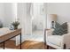 Cozy office space featuring hardwood floors, a comfortable armchair, and an open doorway to a bathroom at 1260 S Emerson St, Denver, CO 80210
