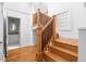Wooden staircase with white risers and walls lead to a bathroom, offering modern fixtures at 1260 S Emerson St, Denver, CO 80210