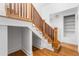 Wooden staircase with white risers and walls lead to the upper level of the home at 1260 S Emerson St, Denver, CO 80210