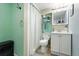 Clean bathroom with a shower, toilet, vanity, and calming light blue accents at 1711 Spruce St, Denver, CO 80220