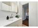 Modern bathroom with a white vanity, stylish faucet, and view to the bedroom at 1711 Spruce St, Denver, CO 80220