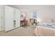 Bright bedroom featuring a mirrored closet and cozy study nook by the window at 1711 Spruce St, Denver, CO 80220