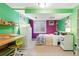 Vibrant bedroom with unique green and purple walls, study space, and cozy décor at 1711 Spruce St, Denver, CO 80220