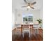 Cozy dining area with natural light, ceiling fan, wood table, and views of the outdoors at 1711 Spruce St, Denver, CO 80220