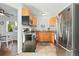 Well-lit kitchen featuring stainless steel appliances, wooden cabinets and tile floors at 1711 Spruce St, Denver, CO 80220