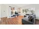 Bright living room featuring hardwood floors, large window, and comfortable sectional sofa at 1711 Spruce St, Denver, CO 80220