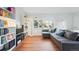 Cozy living room features hardwood floors, large window, and comfortable sectional sofa at 1711 Spruce St, Denver, CO 80220