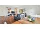 Open-concept living room with large windows, modern decor, and hardwood floors at 1711 Spruce St, Denver, CO 80220