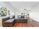 Bright living room featuring hardwood floors, a comfortable sectional, and an adjacent dining area at 1711 Spruce St, Denver, CO 80220