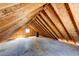 Unfinished attic space with exposed wood beams and ample room for storage or renovation at 36635 View Ridge Dr, Elizabeth, CO 80107