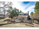 Backyard showing the patio, grassy lawn, fire pit, landscaping, and mature trees at 36635 View Ridge Dr, Elizabeth, CO 80107