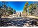 Expansive backyard surrounded by mature trees, ideal for outdoor gatherings and enjoying nature at 36635 View Ridge Dr, Elizabeth, CO 80107