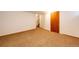 Basement with neutral carpet, access to the stairs, and a door at 36635 View Ridge Dr, Elizabeth, CO 80107