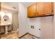 Functional laundry room with a pedestal sink, shower, and cabinets for storage at 36635 View Ridge Dr, Elizabeth, CO 80107