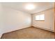 Light-filled bedroom showcasing neutral carpet, a window, and baseboard heating at 36635 View Ridge Dr, Elizabeth, CO 80107