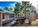 Exterior view of the house featuring a spacious wooden deck and natural surroundings at 36635 View Ridge Dr, Elizabeth, CO 80107