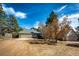 Charming single-story home with attached garage and mature trees under a bright blue sky at 36635 View Ridge Dr, Elizabeth, CO 80107