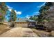 Charming home featuring a two-car garage, front yard with mature trees, and a shed at 36635 View Ridge Dr, Elizabeth, CO 80107