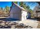 Detached two-car garage with concrete driveway and neutral exterior siding provides ample parking and storage at 36635 View Ridge Dr, Elizabeth, CO 80107