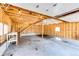 Unfinished garage with wood framing, concrete floor, stairs, lighting and workbench areas provides ample workspace at 36635 View Ridge Dr, Elizabeth, CO 80107