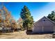 View of the garage showcasing the landscape and autumn trees at 36635 View Ridge Dr, Elizabeth, CO 80107