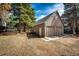 Detached two-car garage with a concrete driveway, and mature trees at 36635 View Ridge Dr, Elizabeth, CO 80107