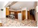 Modern kitchen with granite countertops, wooden cabinets, and an adjacent staircase at 36635 View Ridge Dr, Elizabeth, CO 80107