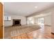 Cozy living room featuring a brick fireplace, plush carpet and sliding glass door access at 36635 View Ridge Dr, Elizabeth, CO 80107