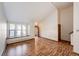 Sunlit living room showcasing hardwood floors, front door, and staircase access at 36635 View Ridge Dr, Elizabeth, CO 80107