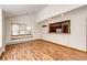 Bright living room features wood floors, a window seat, and an opening to the kitchen at 36635 View Ridge Dr, Elizabeth, CO 80107