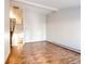 Spacious living room with wood laminate flooring, white walls, and an open staircase leading to the upper level at 36635 View Ridge Dr, Elizabeth, CO 80107