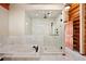 Bathroom boasts a luxurious walk-in shower, jacuzzi tub, and log accents for a warm and inviting design at 4560 Hilltop Rd, Evergreen, CO 80439