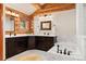 Elegant bathroom featuring dual vanities, a soaking tub, and classic finishes inside this gorgeous log home at 4560 Hilltop Rd, Evergreen, CO 80439
